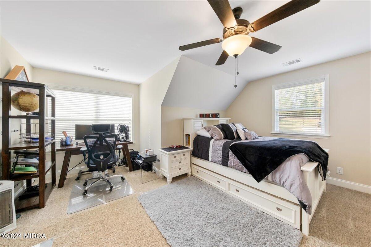 155 Carters Way Forsyth, GA 31029 - Photo 18 of 28 a living room with furniture a large window and gym equipment
