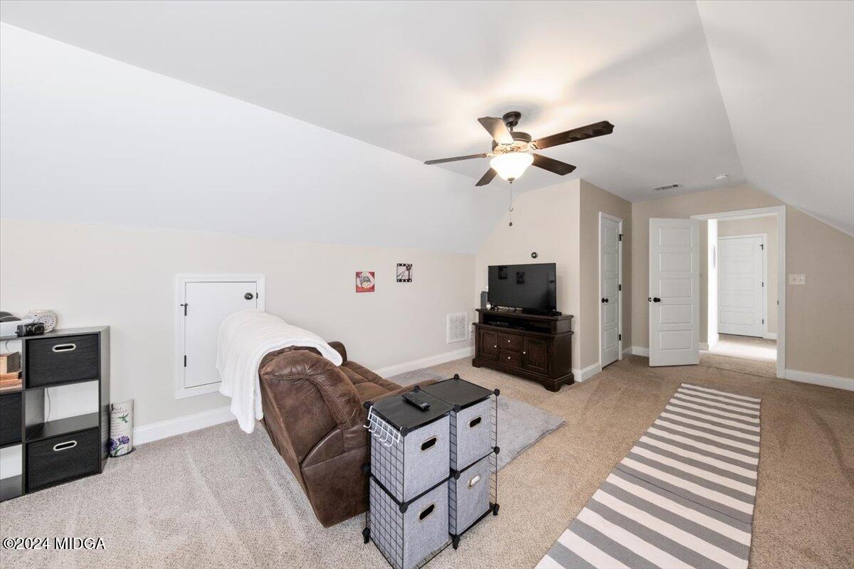 155 Carters Way Forsyth, GA 31029 - Photo 19 of 28 a living room with furniture and a flat screen tv