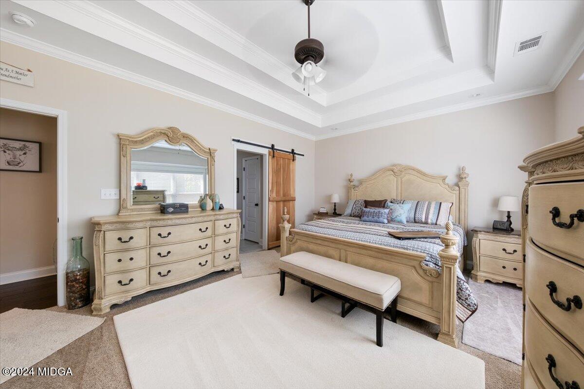 155 Carters Way Forsyth, GA 31029 - Photo 23 of 28 a bedroom with a bed and a dresser in it