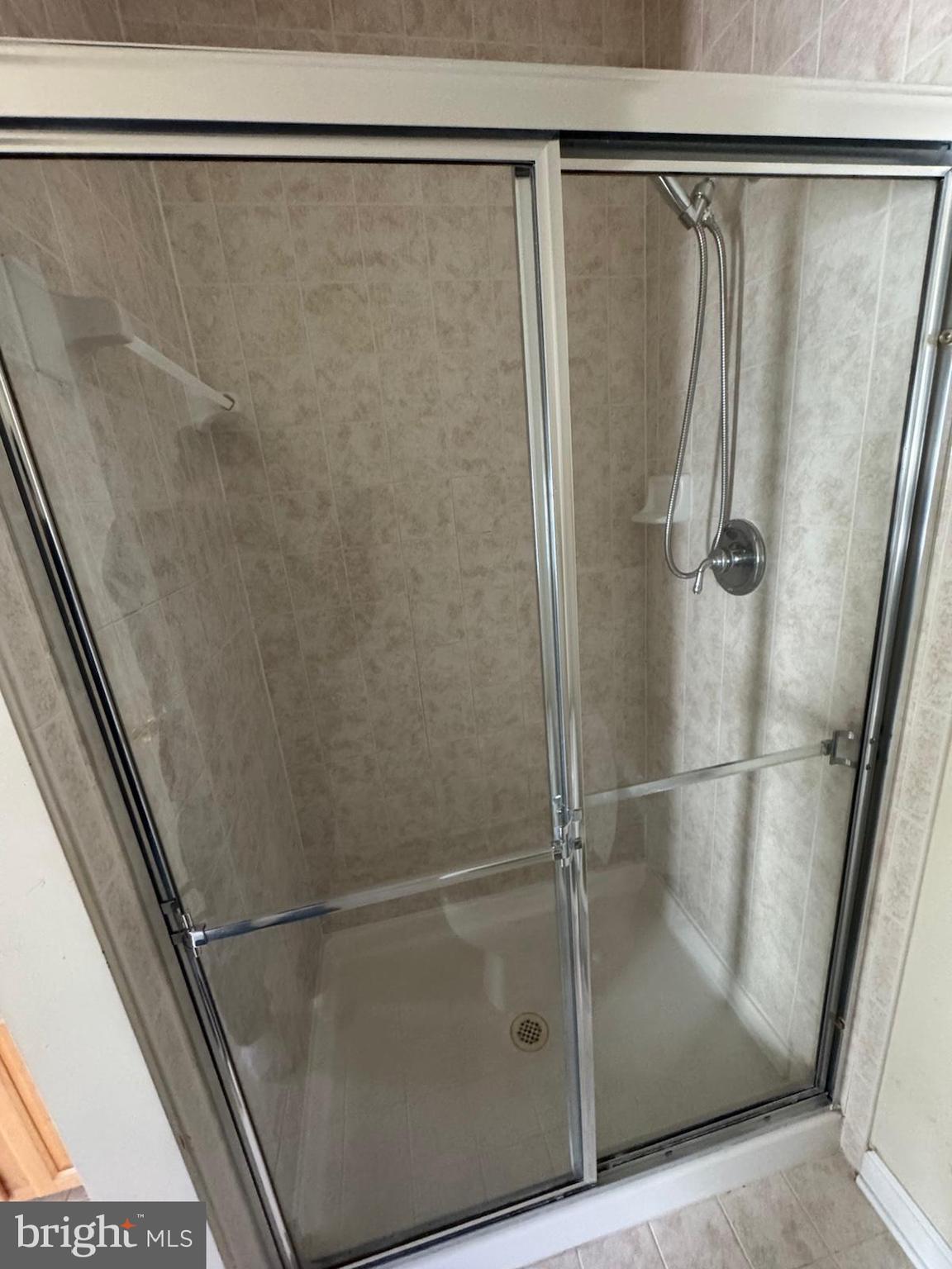 42474 Magellan Square Brambleton, VA 20148 - Photo 21 of 31 a bathroom with a glass shower door