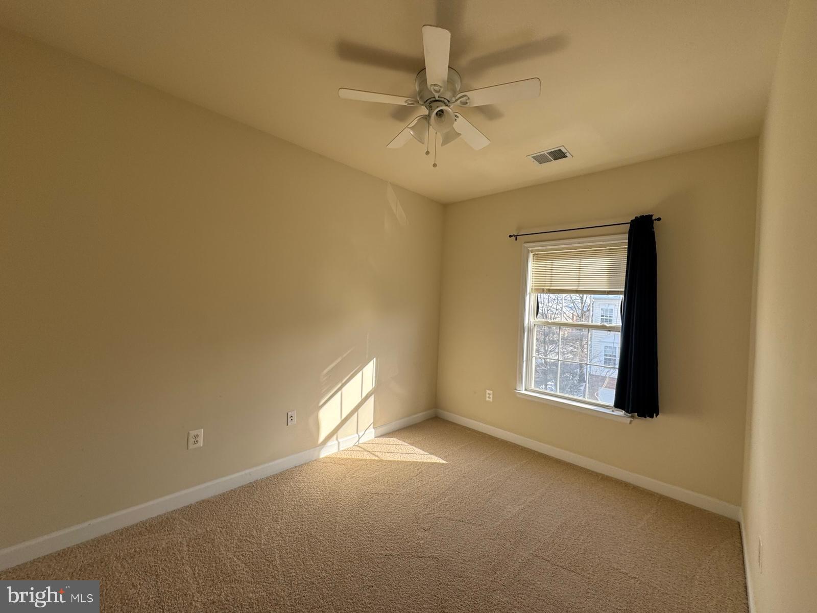 42474 Magellan Square Brambleton, VA 20148 - Photo 29 of 31 an empty room with a window and a ceiling fan
