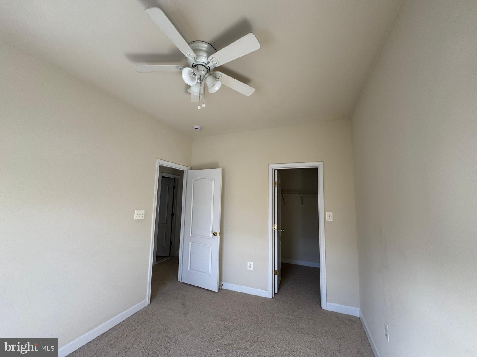 42474 Magellan Square Brambleton, VA 20148 - Photo 30 of 31 an empty room with a ceiling fan and carpet