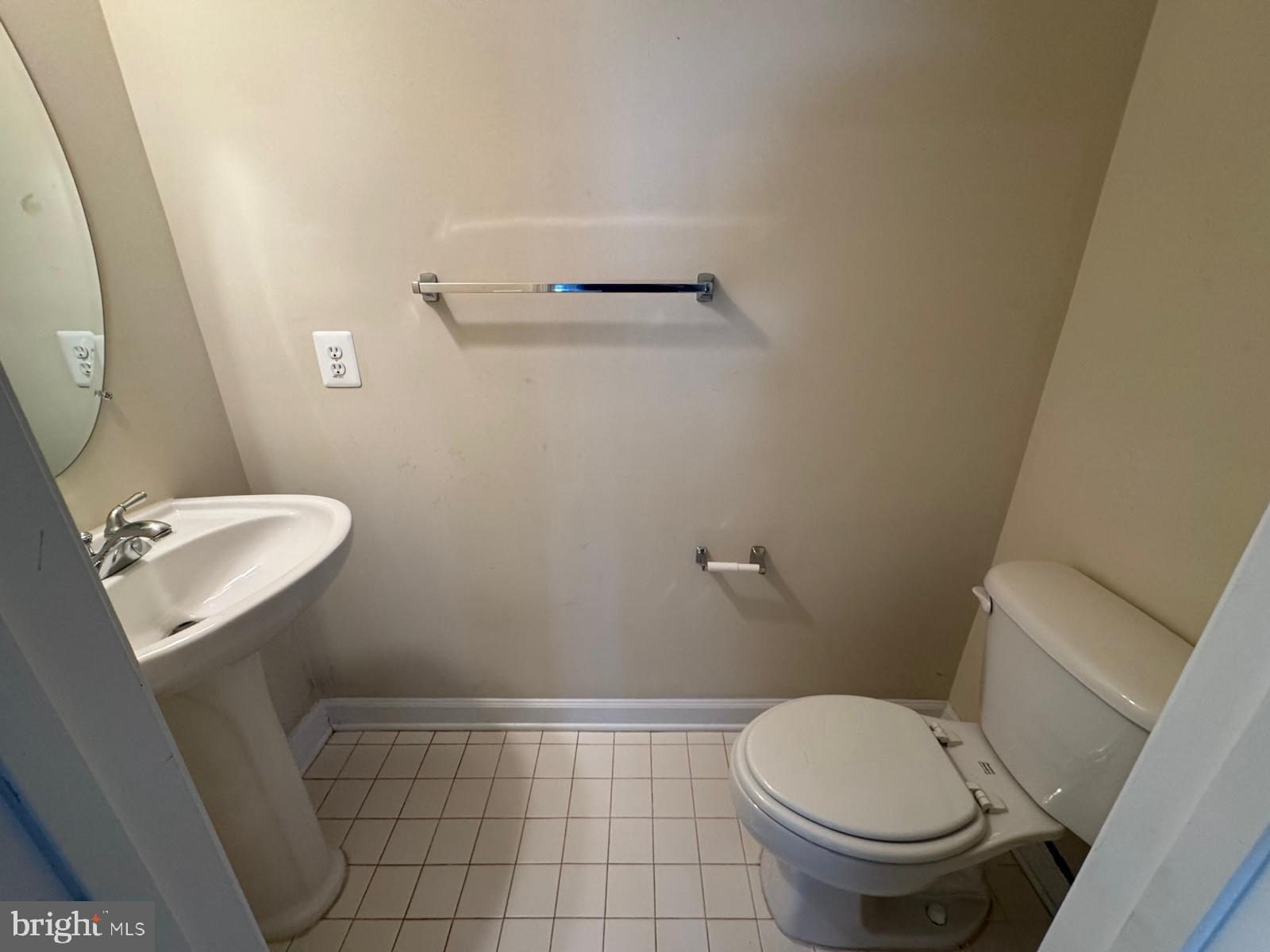 42474 Magellan Square Brambleton, VA 20148 - Photo 7 of 31 a white toilet sitting next to a bathroom sink and a mirror