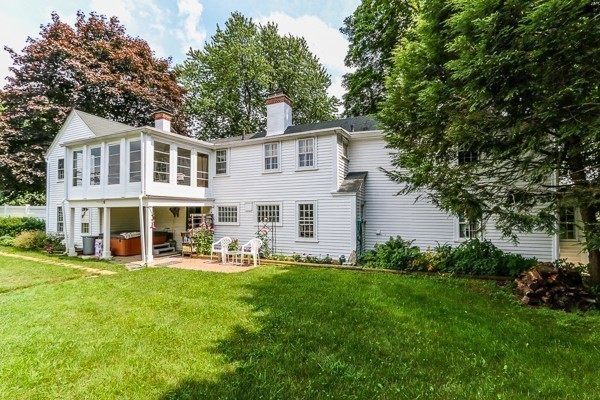 21 Endicott Road Boxford, MA 01921 - Photo 29 of 30 a front view of a house with a yard table and chairs