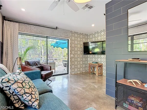 a living room with furniture and a potted plant