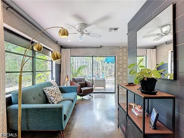 a living room with furniture and a large window