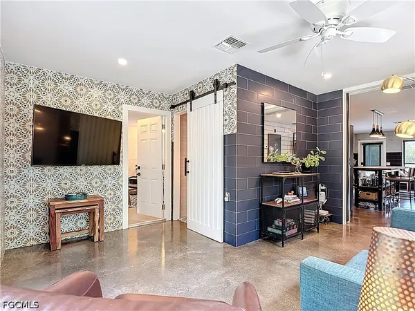 a living room with furniture and wooden floor
