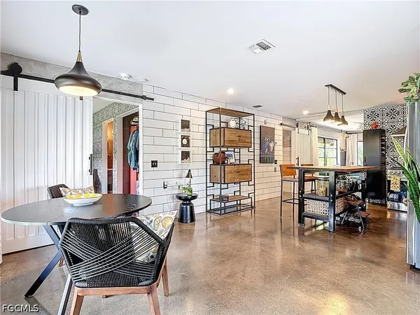 a dining room with furniture and a chandelier