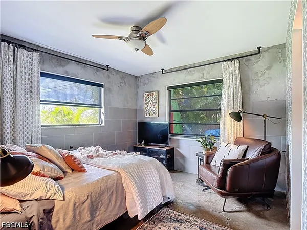 a bedroom with a bed and a flat screen tv