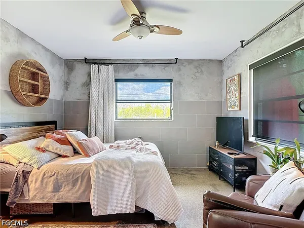 a bedroom with a bed couch and a mirror