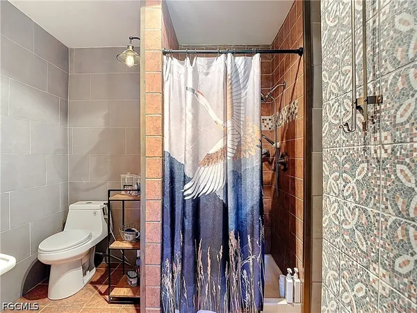 a bathroom with a toilet and shower