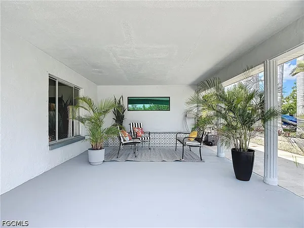 a view of an outdoor space with furniture and umbrella