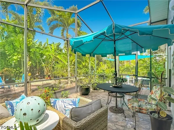 a outdoor living space with furniture and umbrella