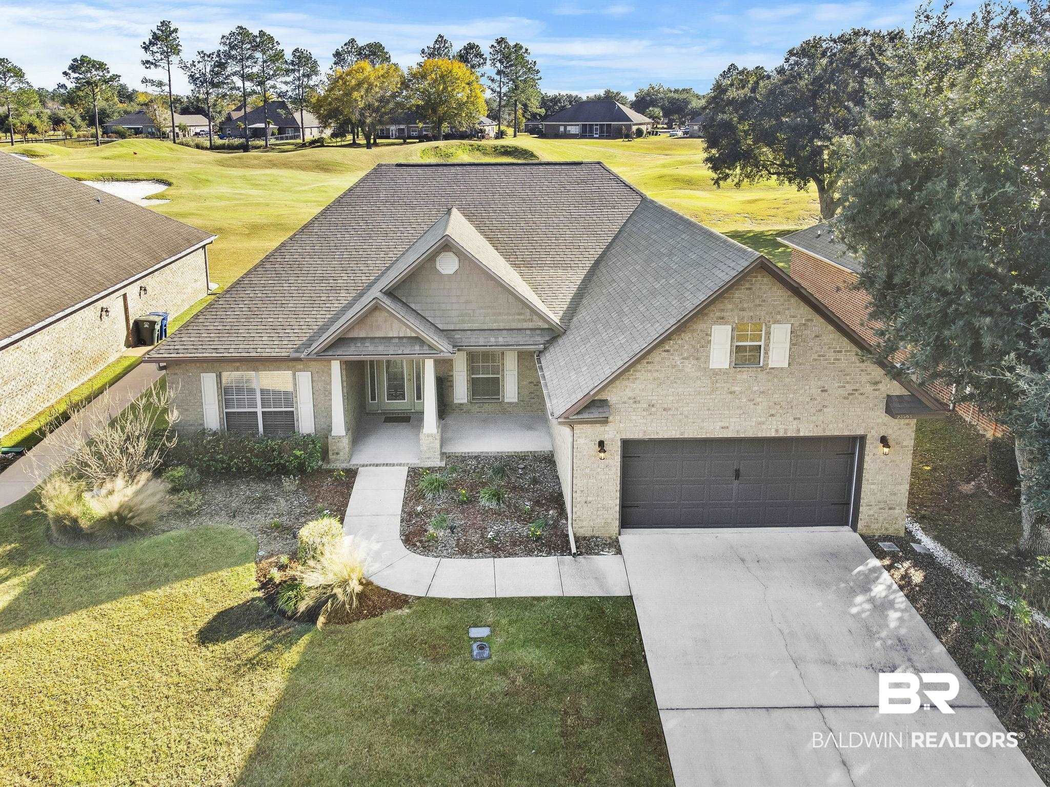 23503 Dundee Circle Foley, AL 36535 - Photo 1 of 83 View of front of house featuring a porch, a garage, and a front lawn