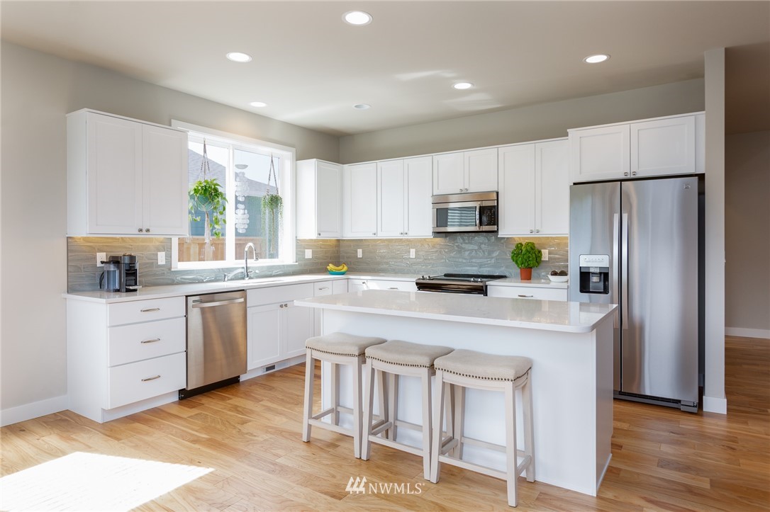11 Lillian Ridge Court Sequim, WA 98382 - Photo 3 of 30 a kitchen with white cabinets and stainless steel appliances