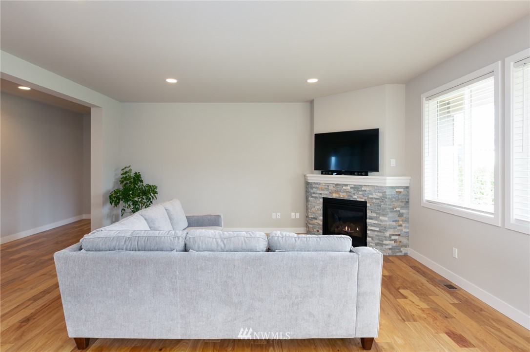 11 Lillian Ridge Court Sequim, WA 98382 - Photo 9 of 30 a living room with furniture a fireplace and a flat screen tv
