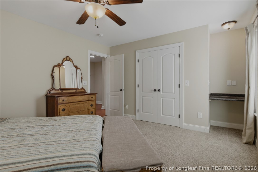 14 Spring Water Court Spring Lake, NC 28390 - Photo 16 of 34 a bedroom with a bed and a chandelier