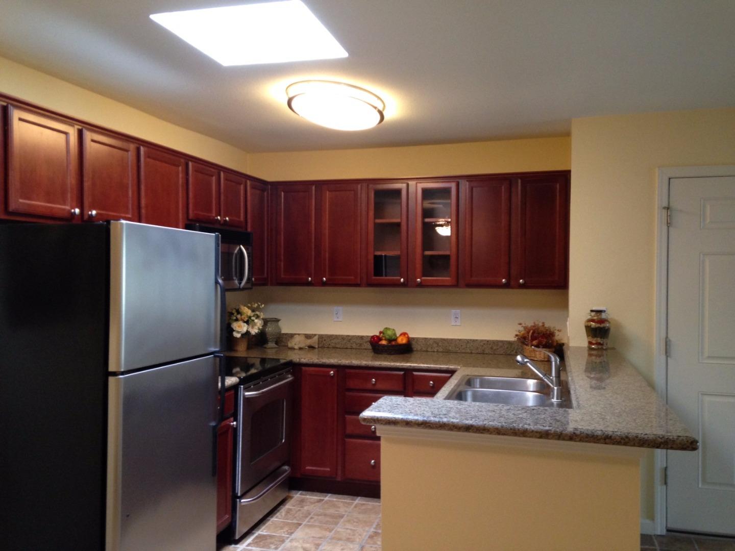 464 Dempsey Road, Unit 265 Milpitas, CA 95035 - Photo 4 of 15 a kitchen with a refrigerator sink and cabinets