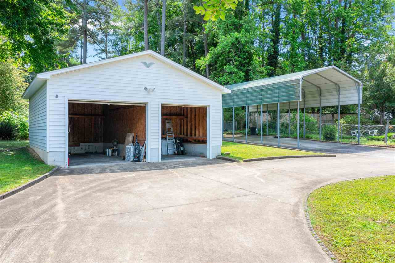 1421 Kelly Road Garner, NC 27529 - Photo 11 of 24 The garage has two bays, one is a full bay for a vehicle, the second is a wired workshop with storage located behind it with a separate door entry. GARAGE/WORKSHOP