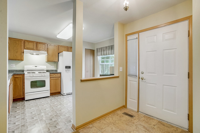 2314 Woodside Drive, Unit 34C2 Carpentersville, IL 60110 - Photo 4 of 6 a view of kitchen with sink refrigerator and window
