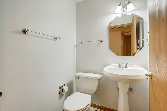 2314 Woodside Drive, Unit 34C2 Carpentersville, IL 60110 - Photo 5 of 6 a bathroom with a toilet sink and mirror