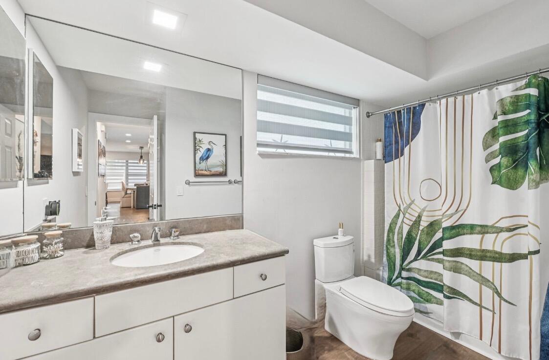 660 Forsyth Street, Unit 7 Boca Raton, FL 33487 - Photo 19 of 27 a bathroom with a granite countertop toilet sink and mirror