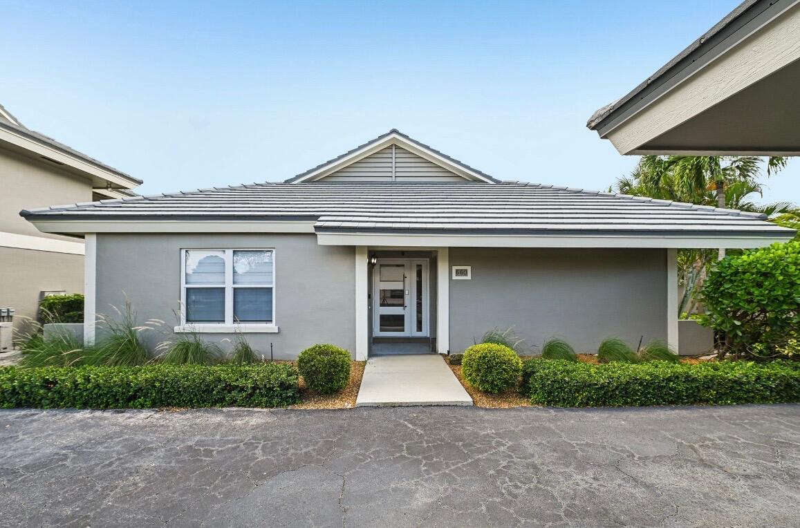 660 Forsyth Street, Unit 7 Boca Raton, FL 33487 - Photo 2 of 27 a front view of a house with garage and plants