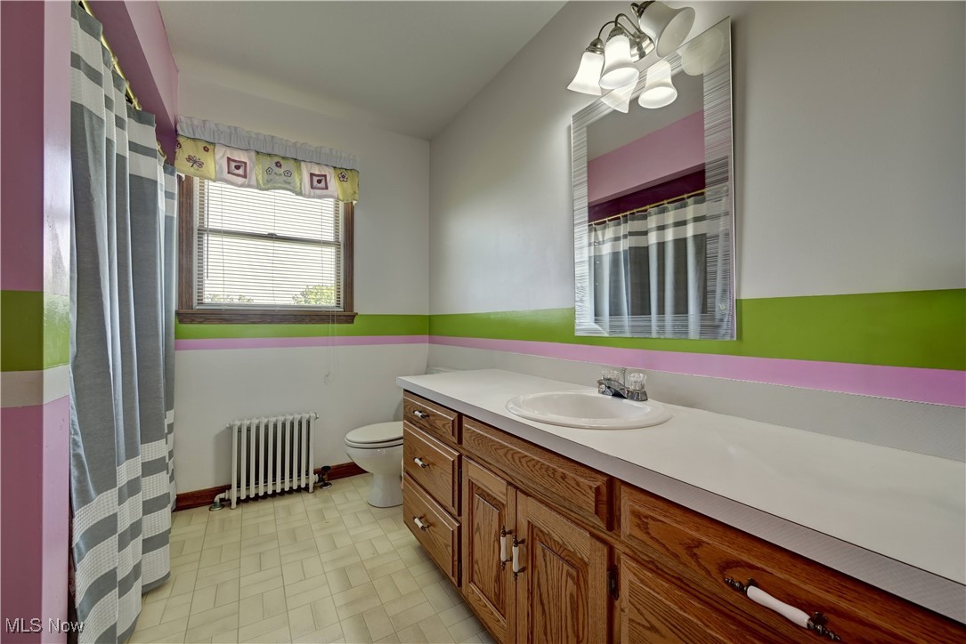 17198 Harrison Road Navarre, OH 44662 - Photo 39 of 45 Bathroom with radiator heating unit and vanity