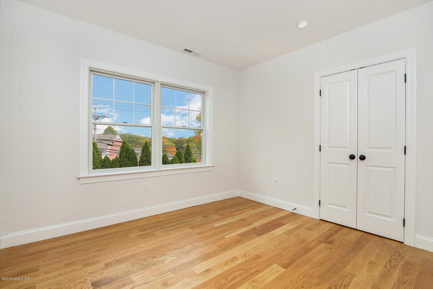 8 Sound Beach Ave Extension, Unit 4 Riverside, CT 06878 - Photo 11 of 25 a view of an empty room with wooden floor and window