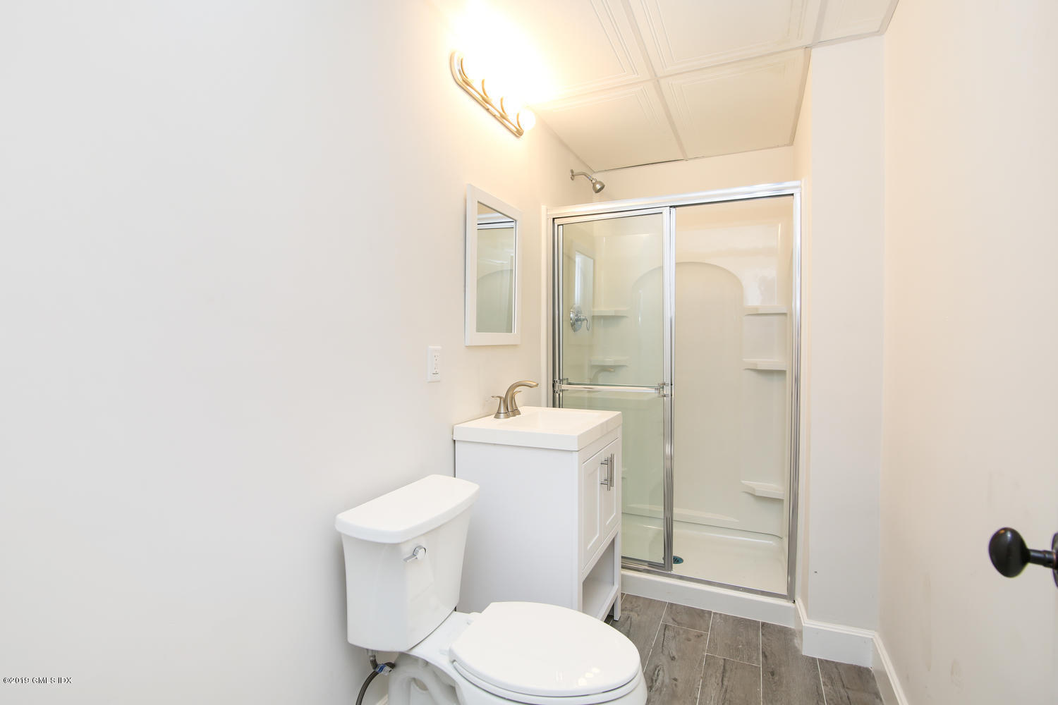 8 Sound Beach Ave Extension, Unit 4 Riverside, CT 06878 - Photo 20 of 25 a white toilet sitting next to a bathroom sink