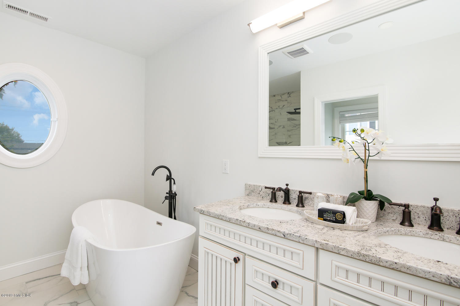 8 Sound Beach Ave Extension, Unit 4 Riverside, CT 06878 - Photo 9 of 25 a bathroom with a granite countertop sink and a mirror