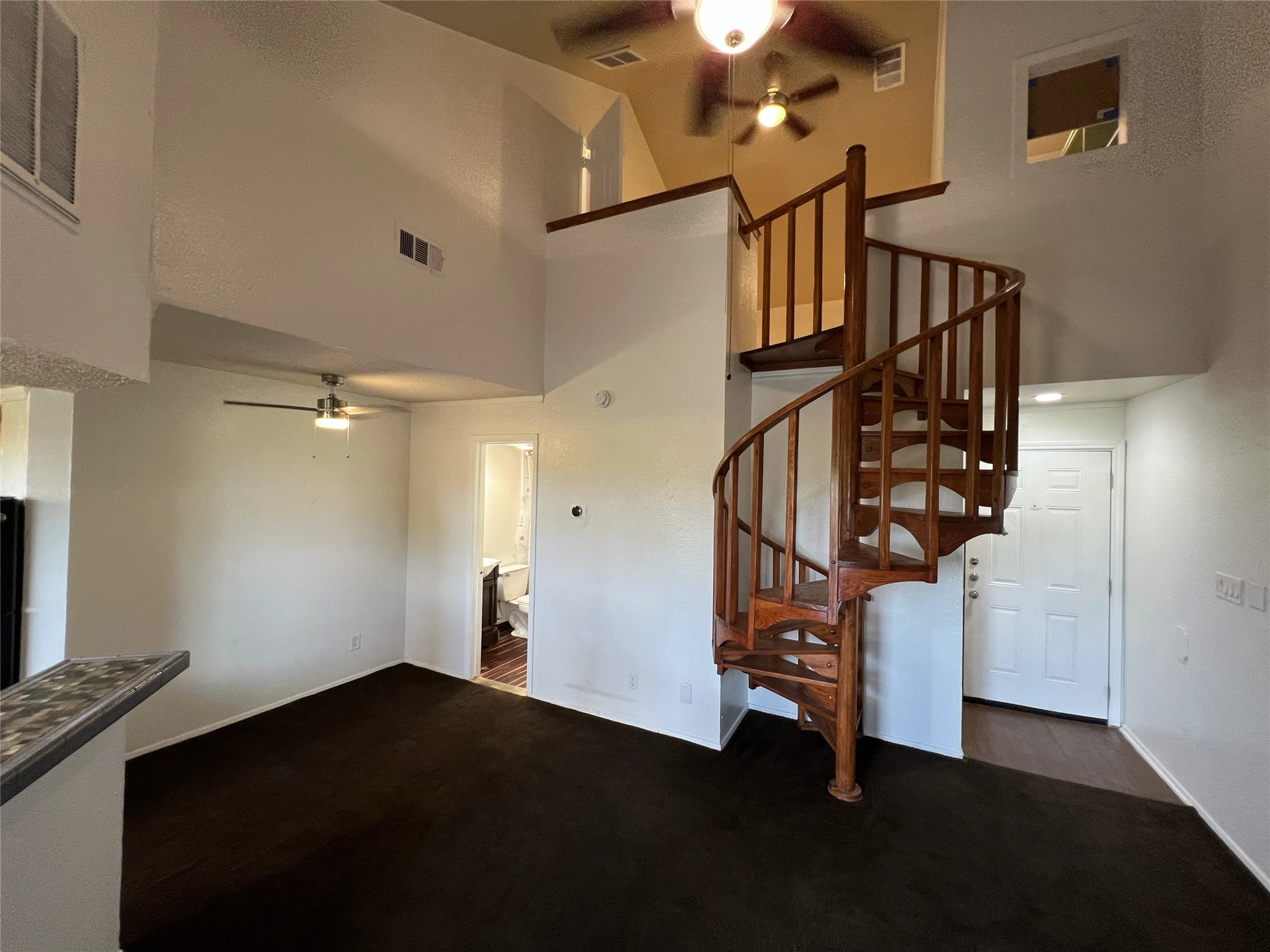 2500 Burleson Road, Unit 622 Austin, TX 78741 - Photo 2 of 17 A unique spiral staircase adds architectural interest to this living area.