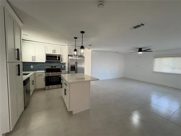 a kitchen with cabinets and white appliances