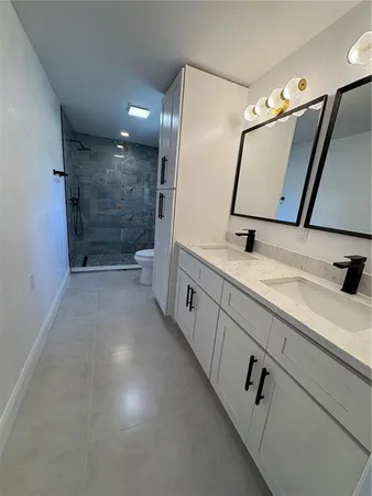 a bathroom with a sink a mirror and a shower