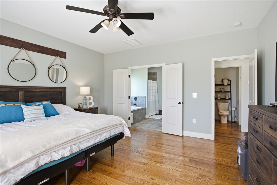 426 Oak Creek Road Seneca, SC 29678 - Photo 17 of 50 This restful bedroom offers a private bathroom entry, high ceilings, and gleaming hardwood floors.