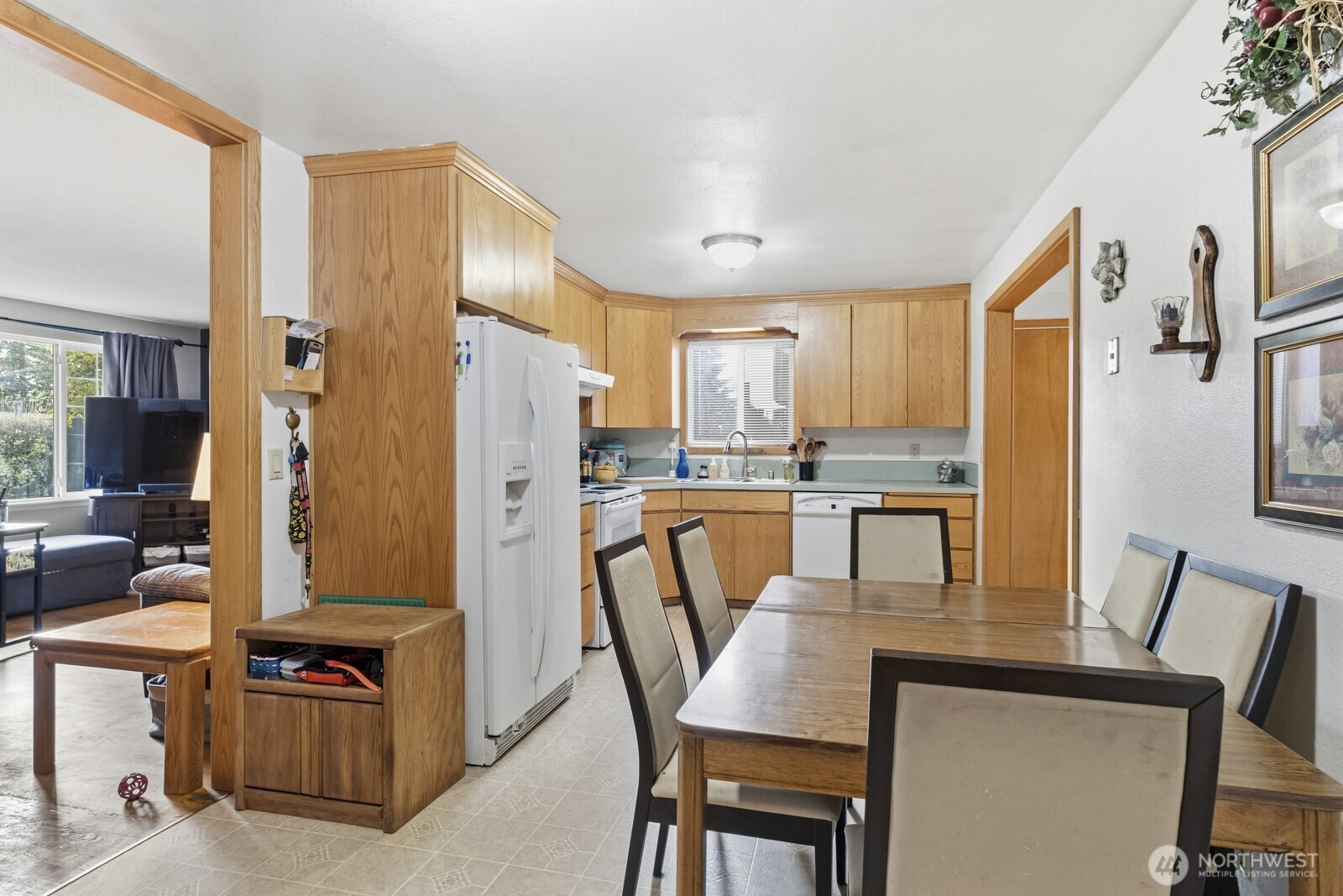 237 167th Street South Spanaway, WA 98387 - Photo 11 of 30 a kitchen with stainless steel appliances granite countertop a refrigerator a stove top oven and a dining table with granite countertop
