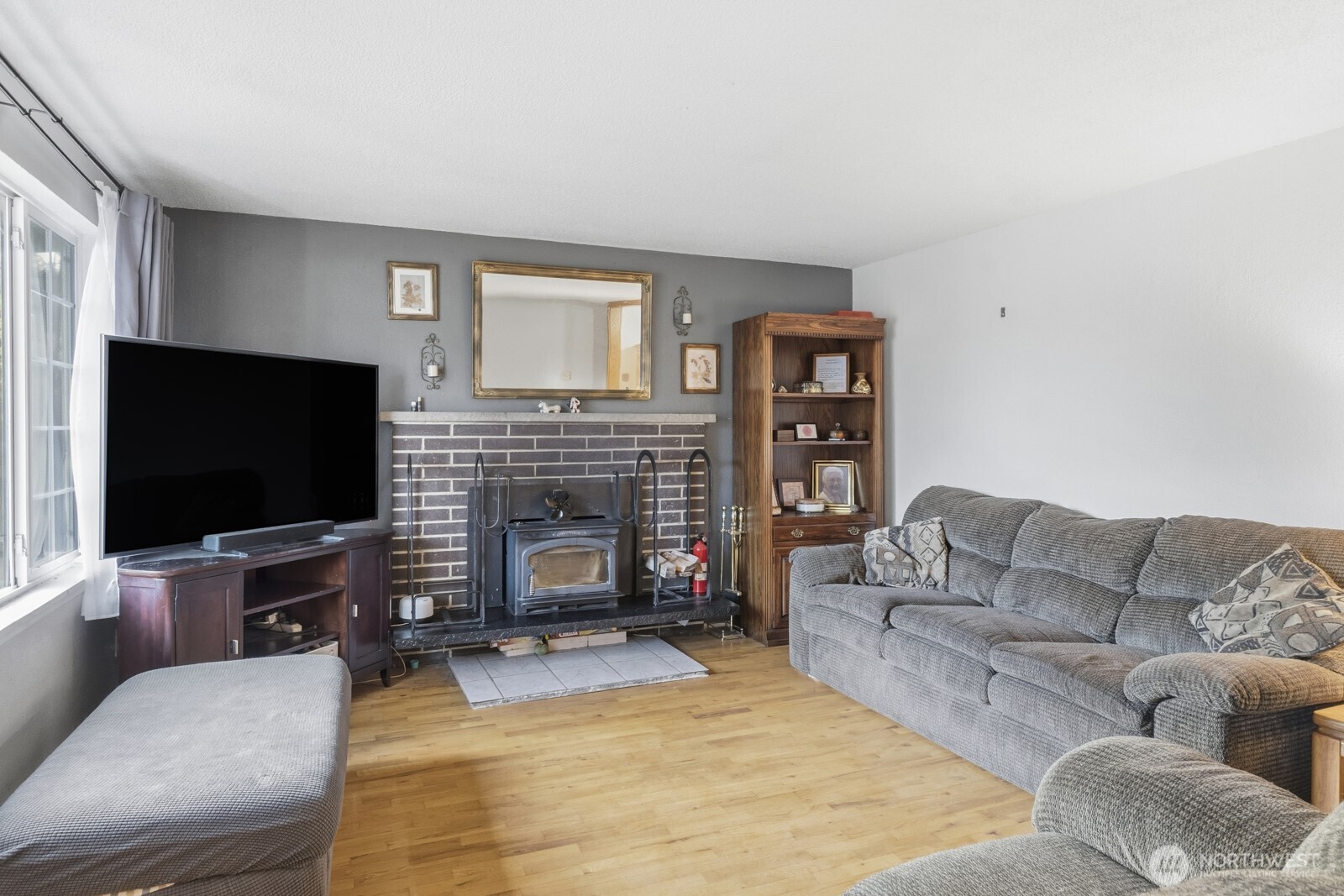 237 167th Street South Spanaway, WA 98387 - Photo 5 of 30 a living room with furniture a flat screen tv and a fireplace