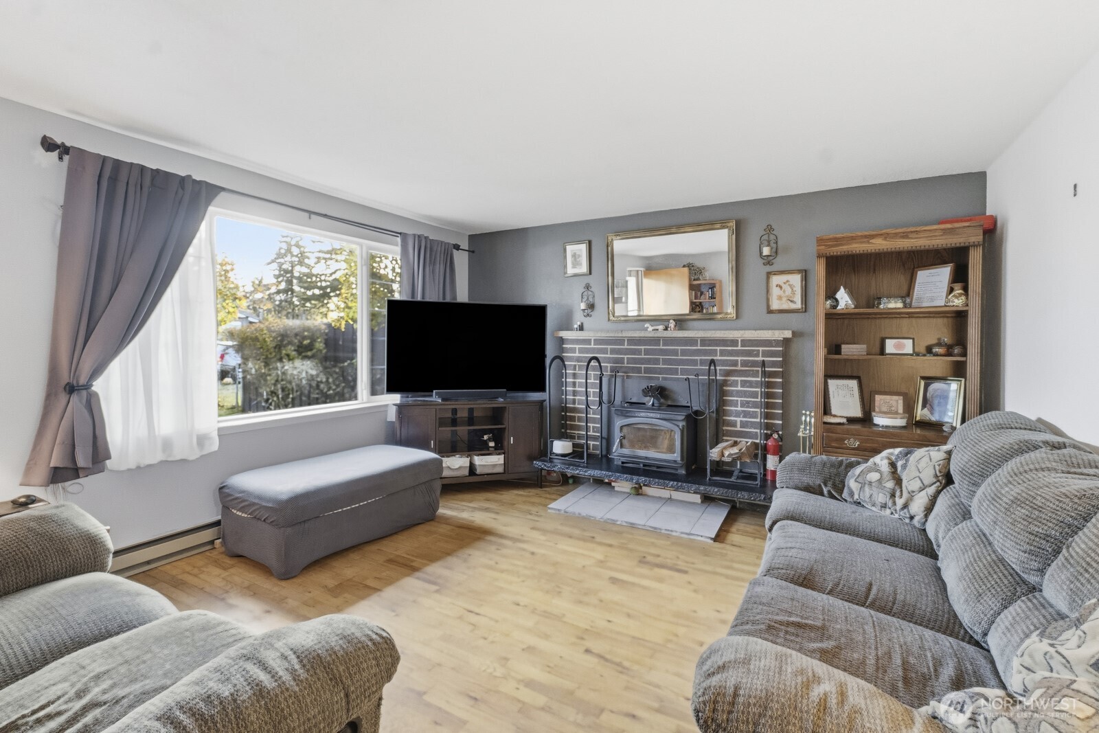 237 167th Street South Spanaway, WA 98387 - Photo 6 of 30 a living room with furniture flat screen tv and a fireplace