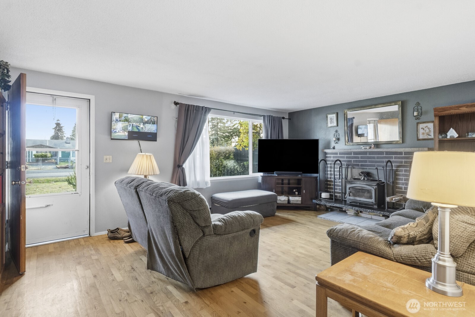 237 167th Street South Spanaway, WA 98387 - Photo 9 of 30 a living room with furniture a flat screen tv and a fireplace