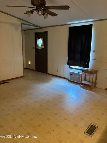 a view of a livingroom with furniture and a ceiling fan