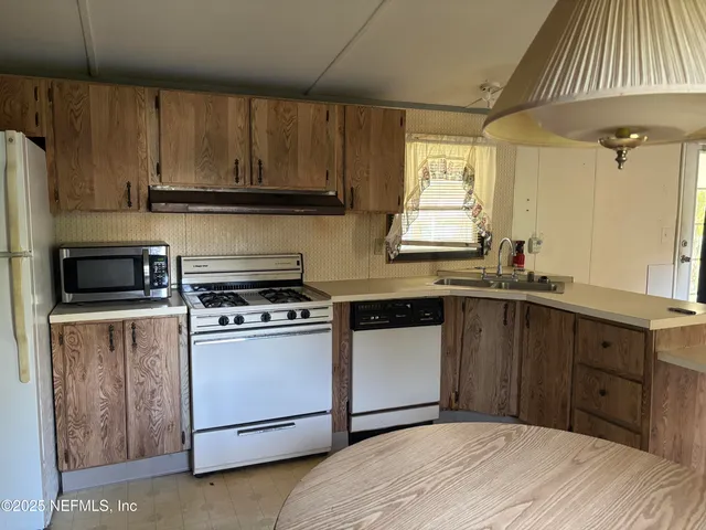 a kitchen with a sink and a stove top oven