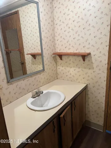 a bathroom with a sink and a mirror