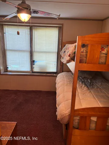 a view of a room that has a bed and a window