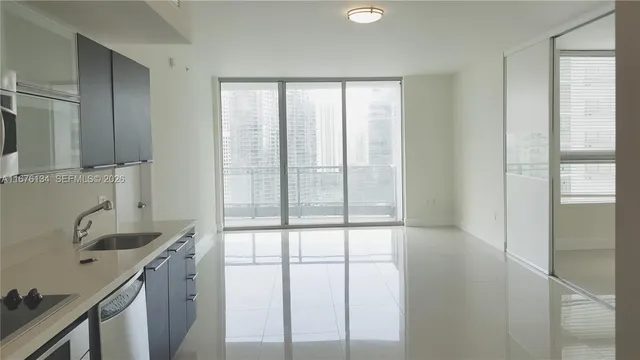 a view of a sink and a window in a kitchen