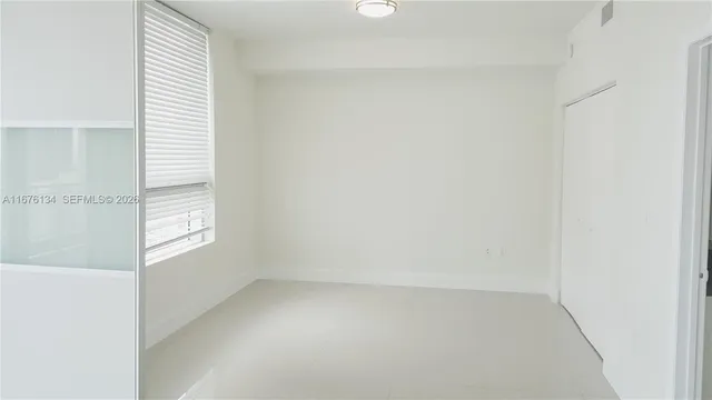 a view of an empty room and a window