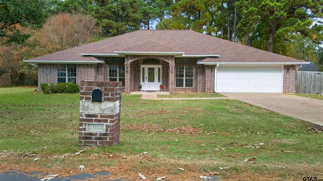 a front view of a house with a garden and porch