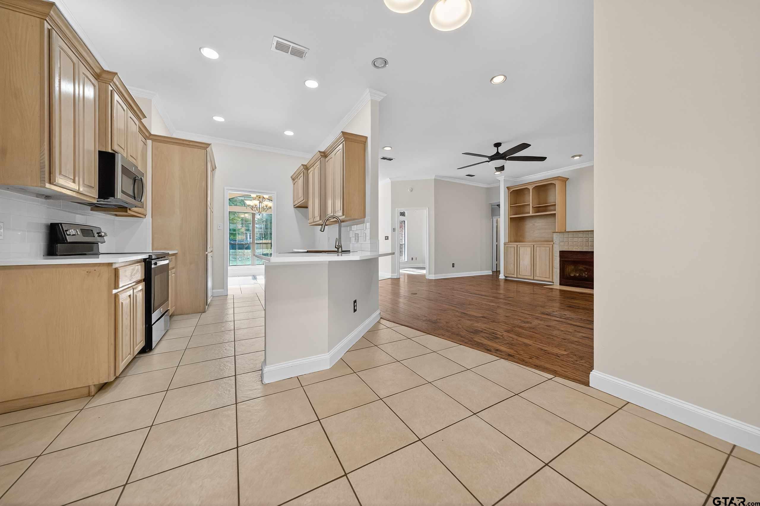 21112 Altuda Lane Flint, TX 75762 - Photo 14 of 48 a kitchen with stainless steel appliances kitchen island granite countertop a sink and cabinets
