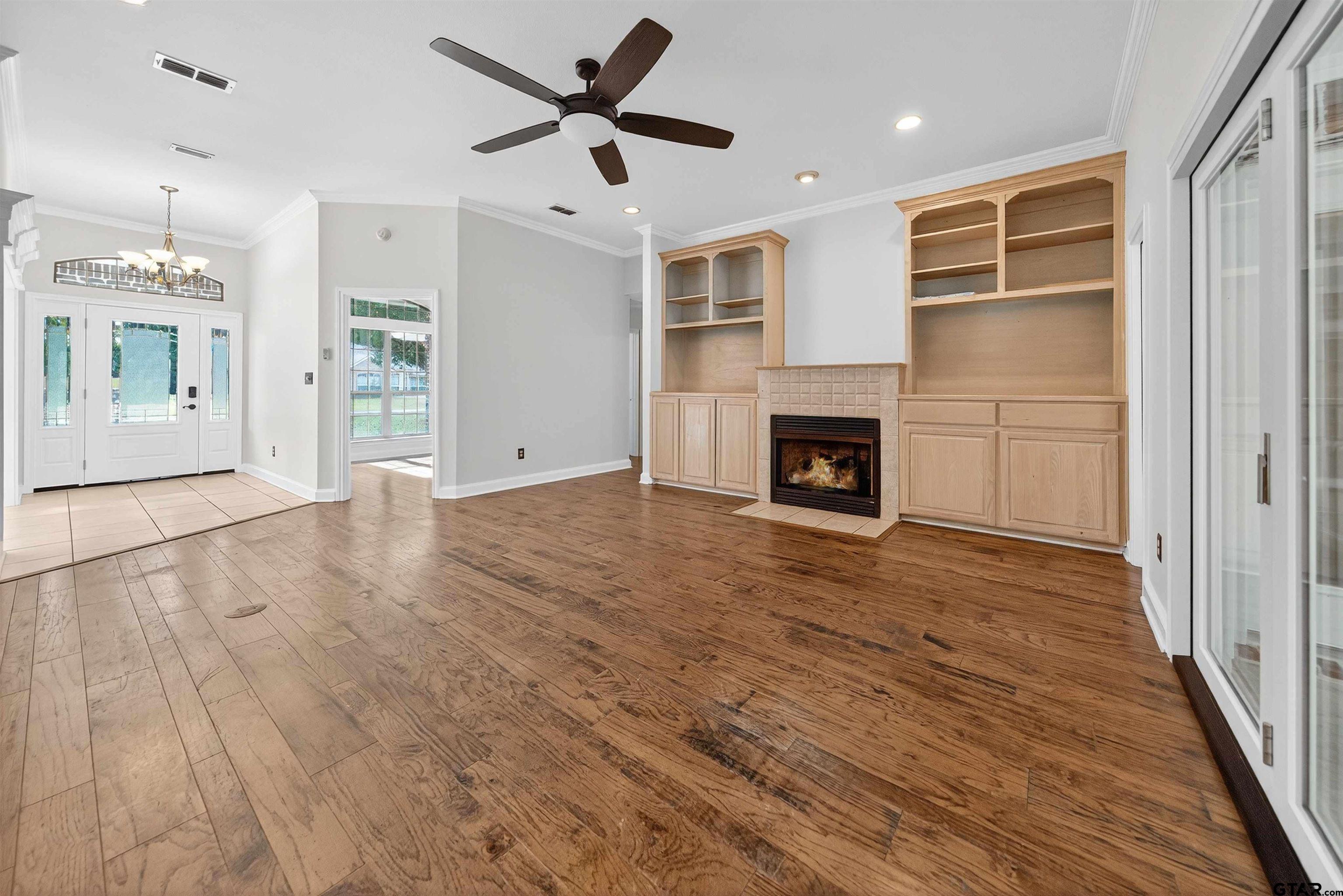 21112 Altuda Lane Flint, TX 75762 - Photo 16 of 48 an empty room with wooden floor fireplace and windows
