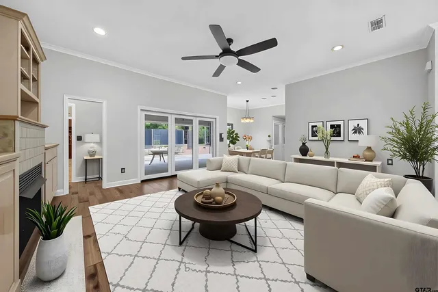 a living room with furniture a fireplace and a chandelier