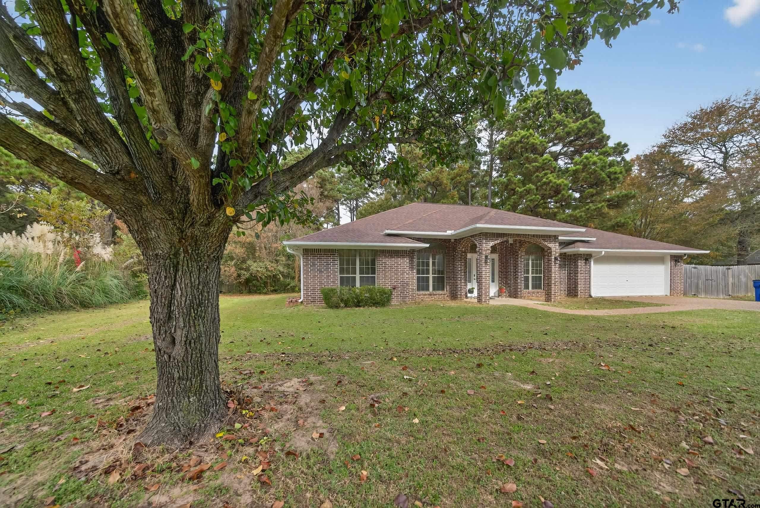 21112 Altuda Lane Flint, TX 75762 - Photo 2 of 48 a view of a yard in front of a house with large trees